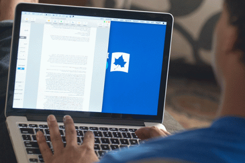  Computer Science- Over the shoulder image of a Black student using a laptop with “Indiana State Online” on the screen and the Sycamore leaf logo. 